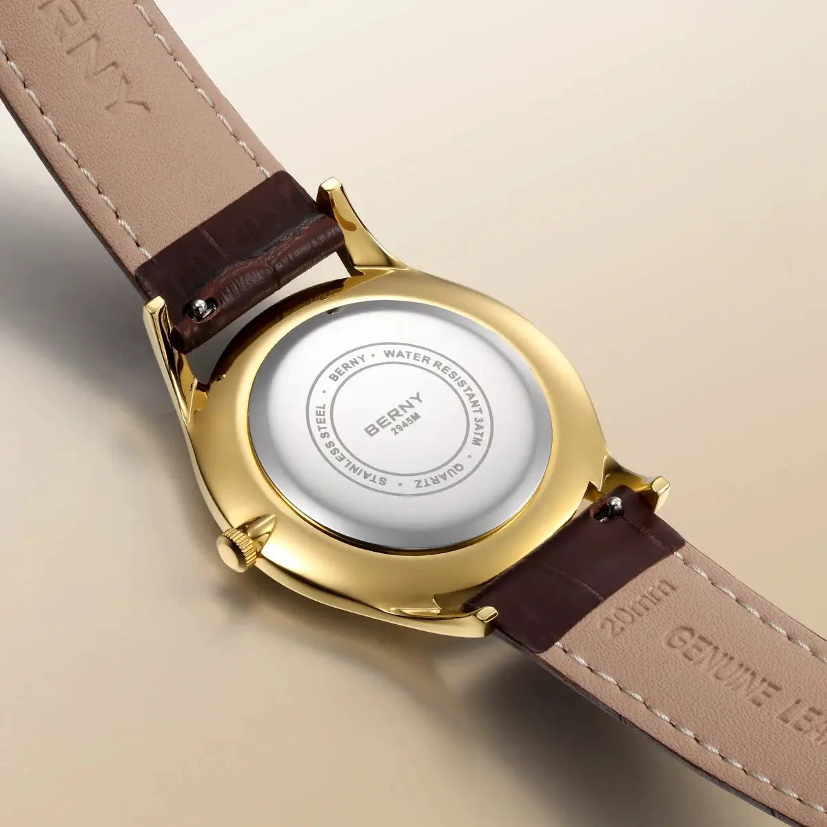 BERNY luxury men's watch with gold-tone case and tan brown leather strap; back shows BERNY branding.