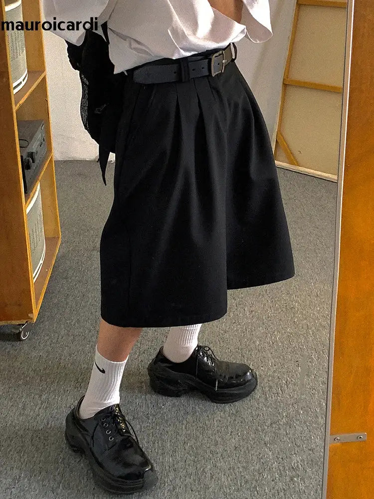 Mauroicardi black pleated men's shorts with high waist, paired with a white shirt and black chunky shoes