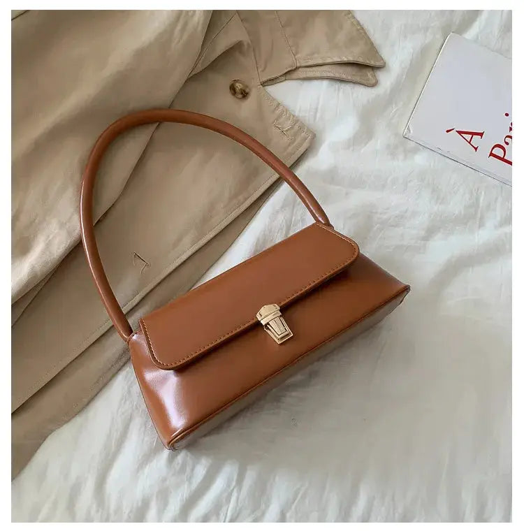 Fashion retro women's shoulder bag in tan brown leather with a top handle and gold clasp.