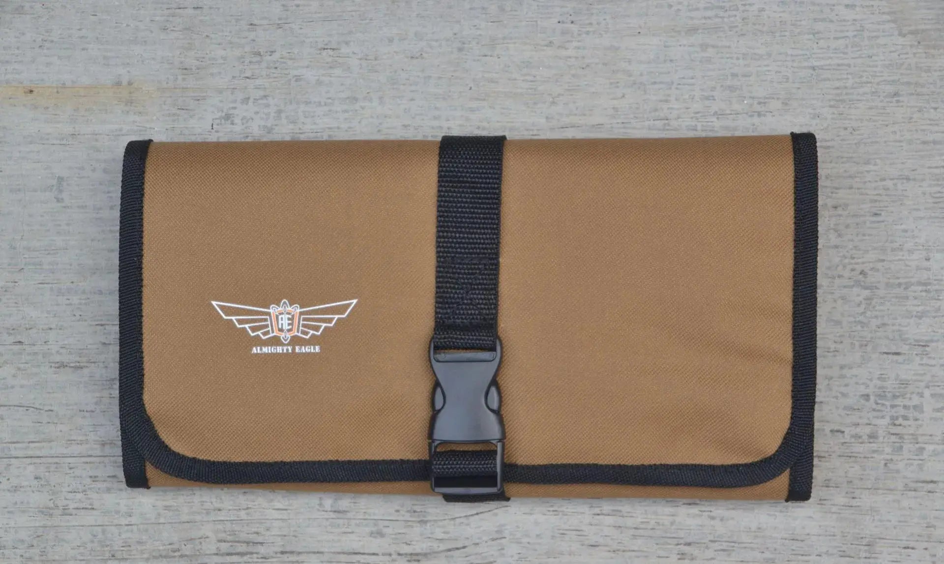 Roll-up tool pouch in tan Oxford cloth with black strap and Almighty Eagle logo