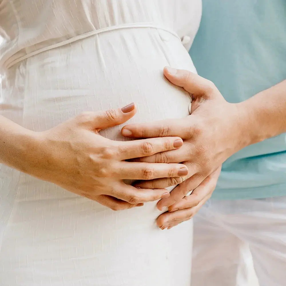 SAMODRA Ultra Slim Bidet Attachment by Simples Market — white dress, hands cradling a pregnant belly