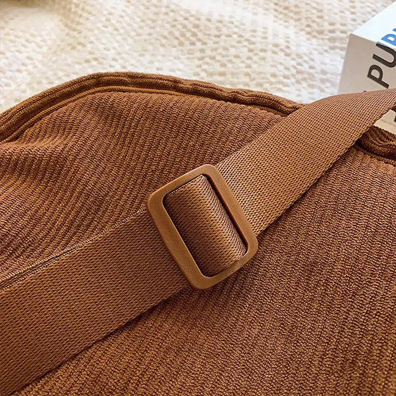 Solid brown corduroy women's hobo shoulder bag by Simples Market with adjustable strap and buckle