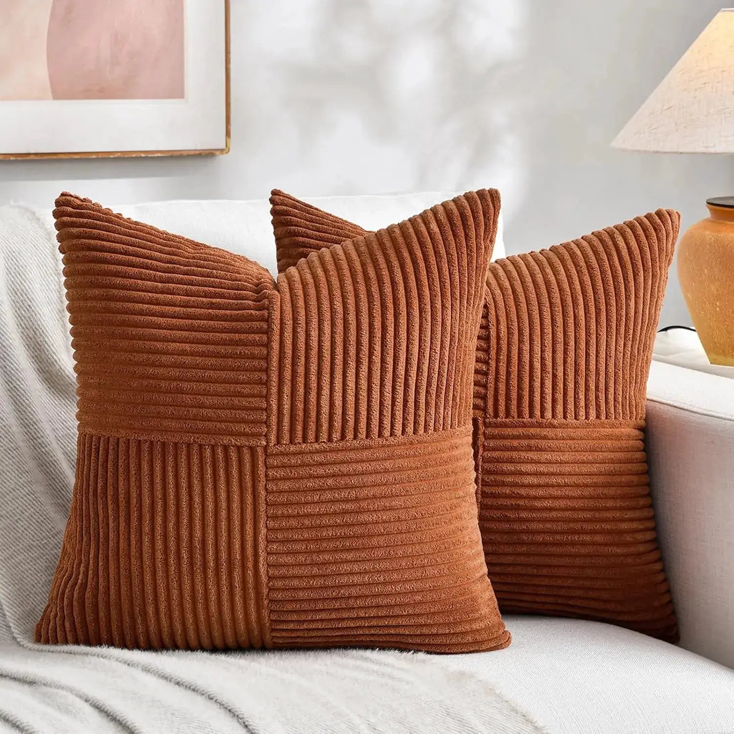 Rust corduroy 18x18 throw pillow covers set of 3 with ribbed patchwork on a white sofa