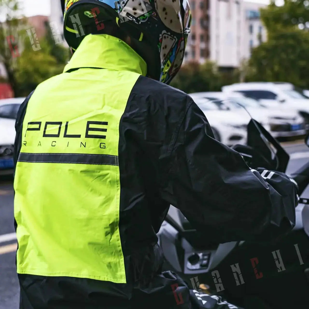 Pole Racing motorcycle raincoat set in neon hi-vis yellow with reflective stripe worn by rider on a motorcycle