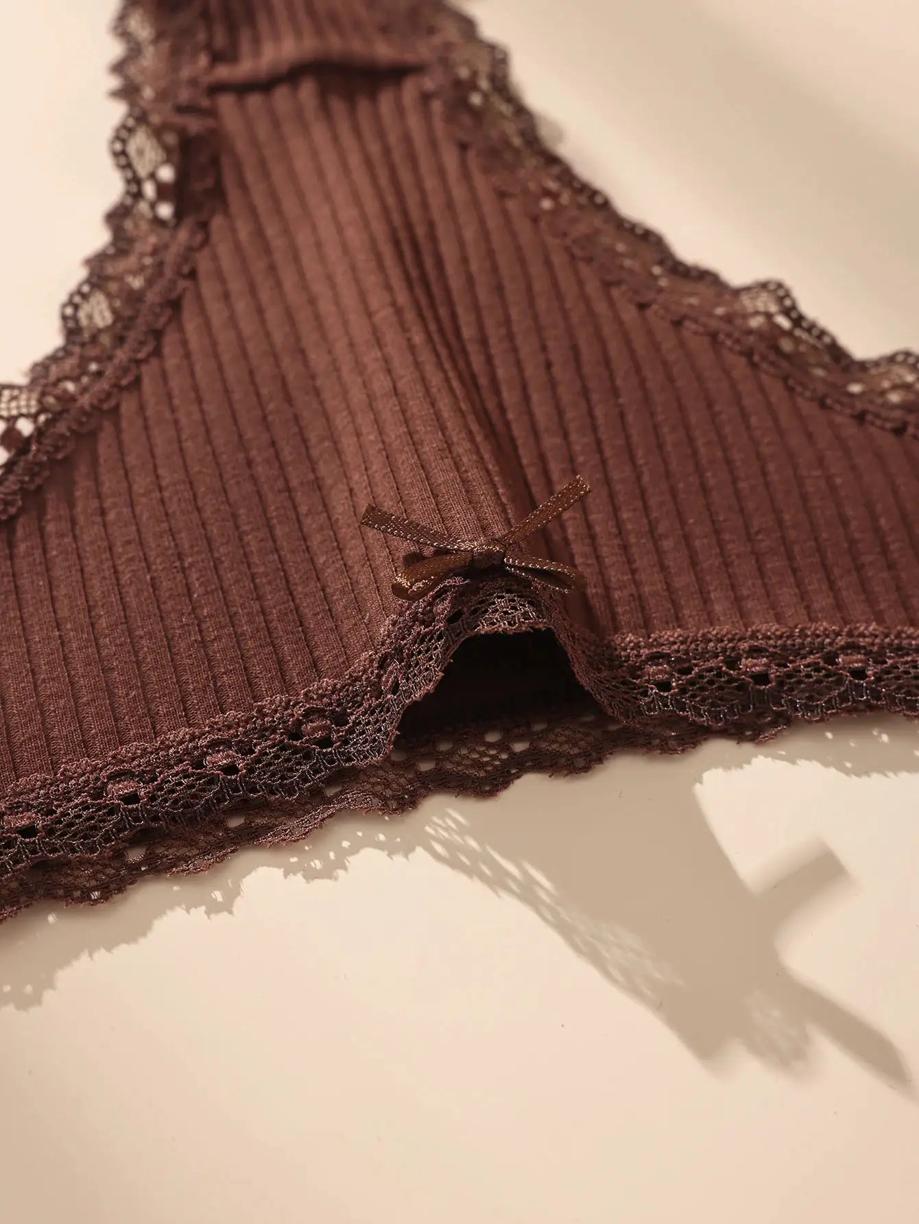 7-piece brown cotton thong set with ribbed fabric, lace trim, and bow detail