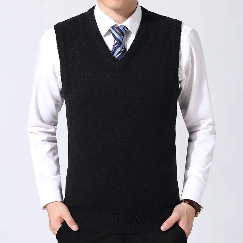 Men's black knit sweater vest over white dress shirt