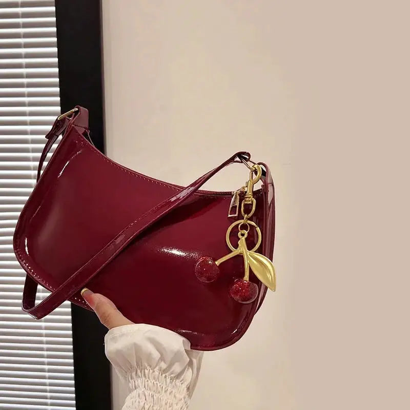 Women's burgundy PU leather shoulder bag with cherry pendant charm