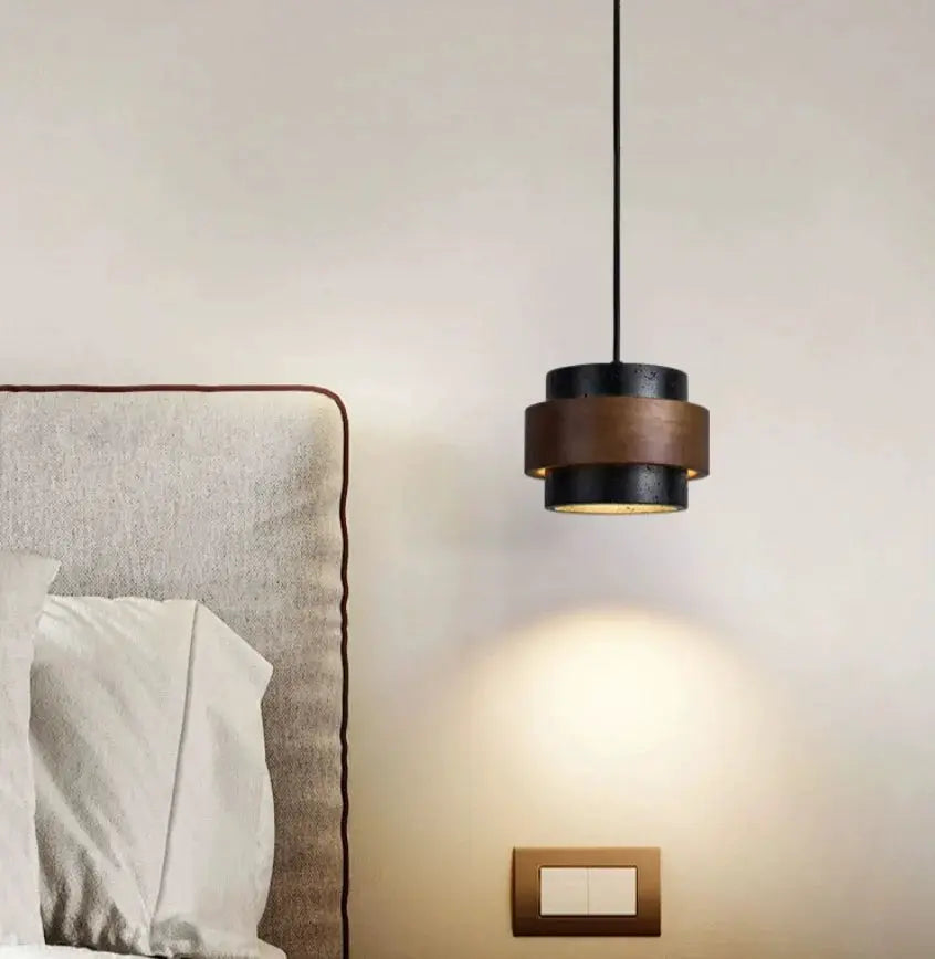 Japanese Wabi Sabi style bar pendant lamp, black with brown band, hanging over bed.