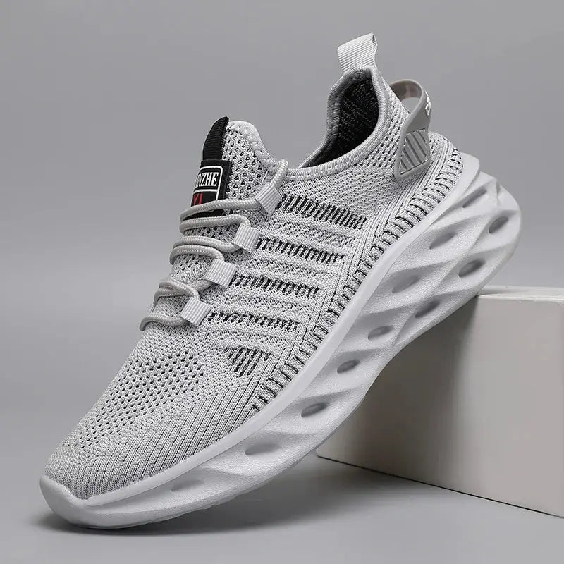 Unisex gray knit running sneaker with breathable mesh and sculpted white sole