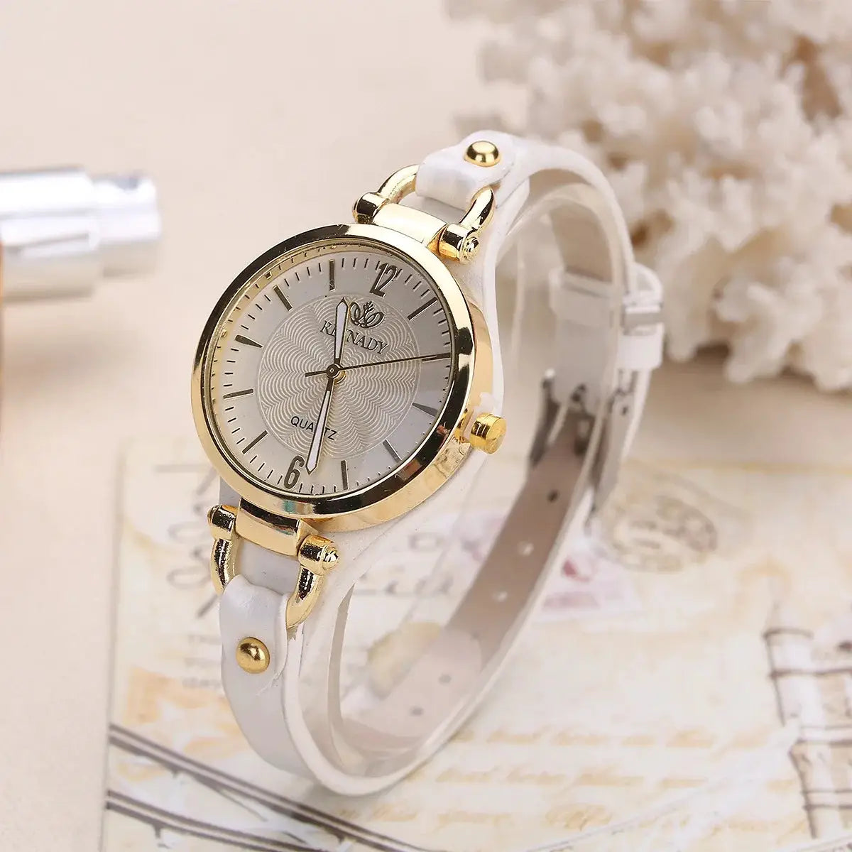 Women's fashion watch with white leather strap and gold-tone case