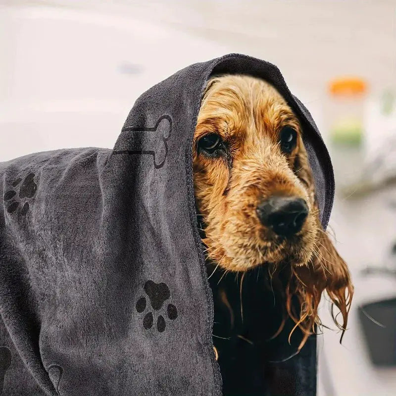 Simples Market gray microfiber dog towel with paw print design draped over a wet dog