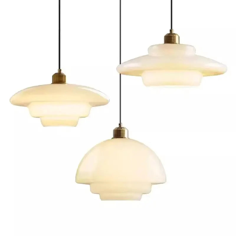 Nordic glass pendant lamp set of three with cream glass shades and brass fittings.