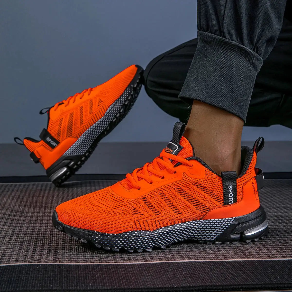 Men's orange running shoes with breathable mesh, lace-up, black non-slip speckled sole