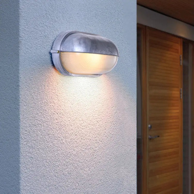 Outdoor retro LED wall lamp by Simples Market; IP65 waterproof gray metal sconce with glass diffuser