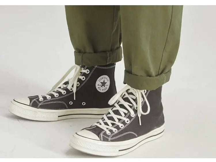 HIQOR olive cargo pants with belt paired with black Converse All Star high-top sneakers
