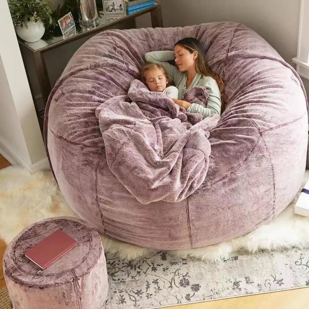 Giant lavender plush bean bag sofa bed with a matching round ottoman for cozy lounging