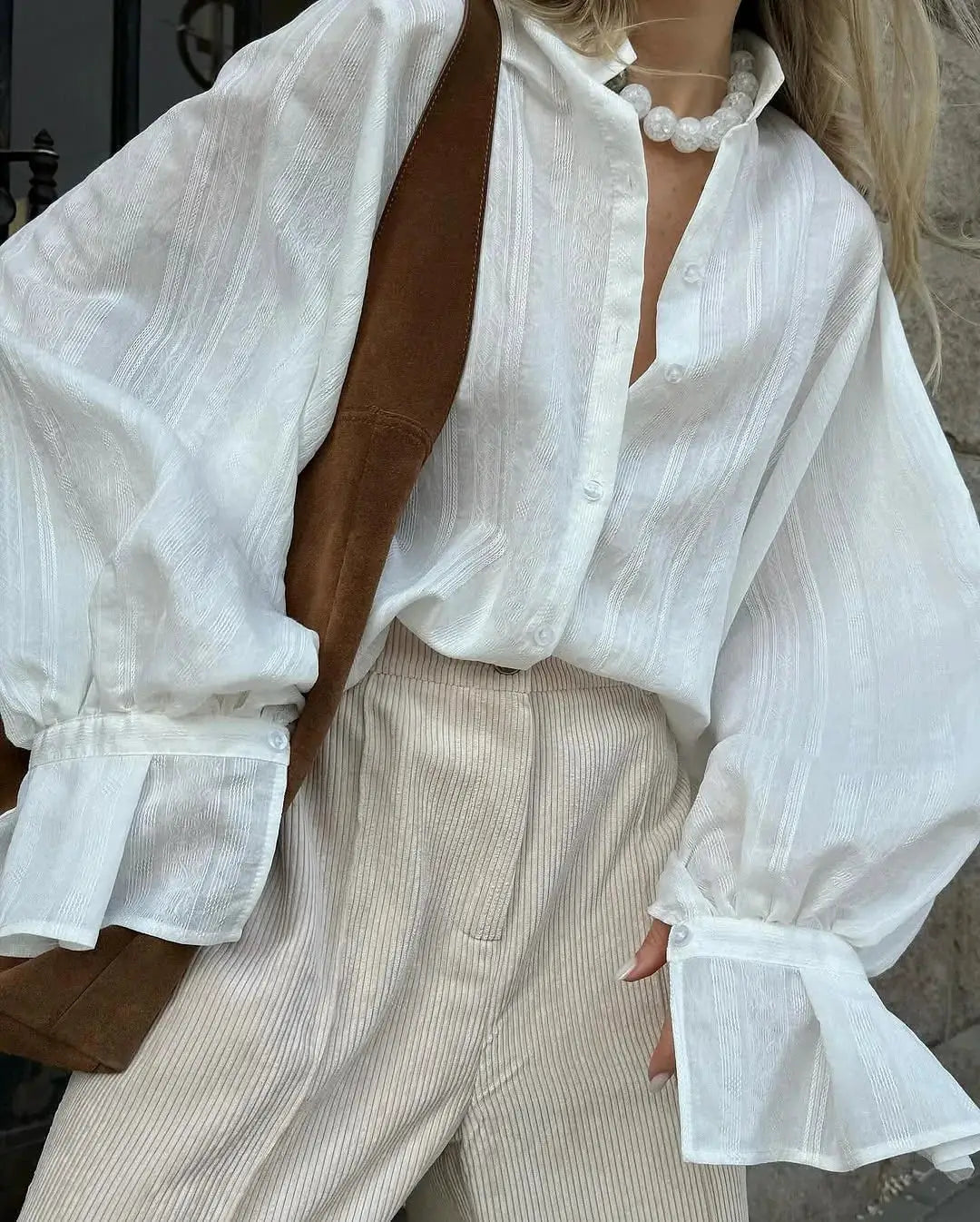 Women's oversized white cotton shirt with long sleeves and button front.