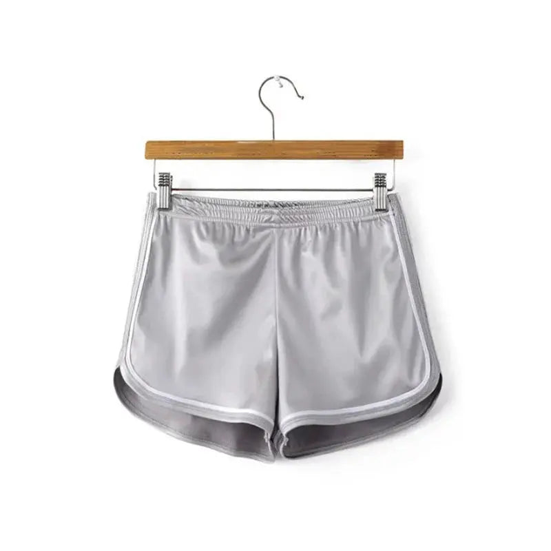 Women's silk shorts in light gray with white piping, elastic waistband and curved hems, beach casual