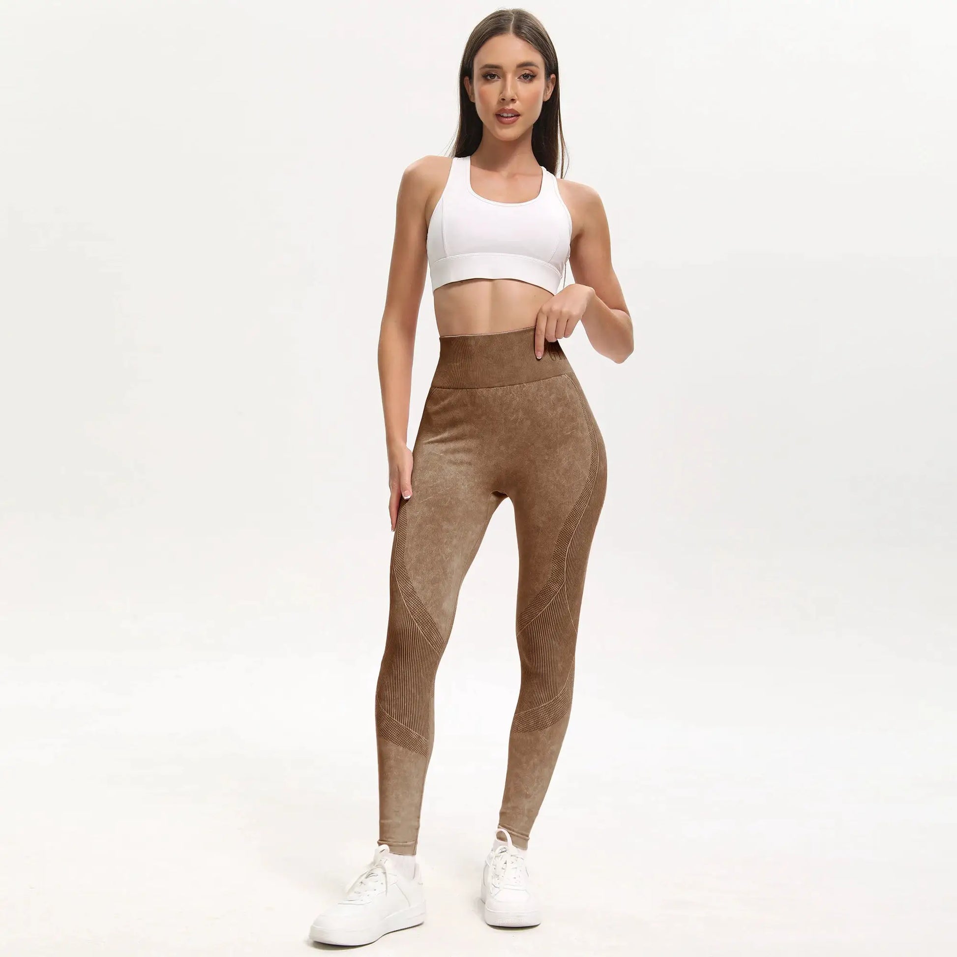 Women's brown high-waisted seamless yoga leggings with breathable fabric and textured panels.