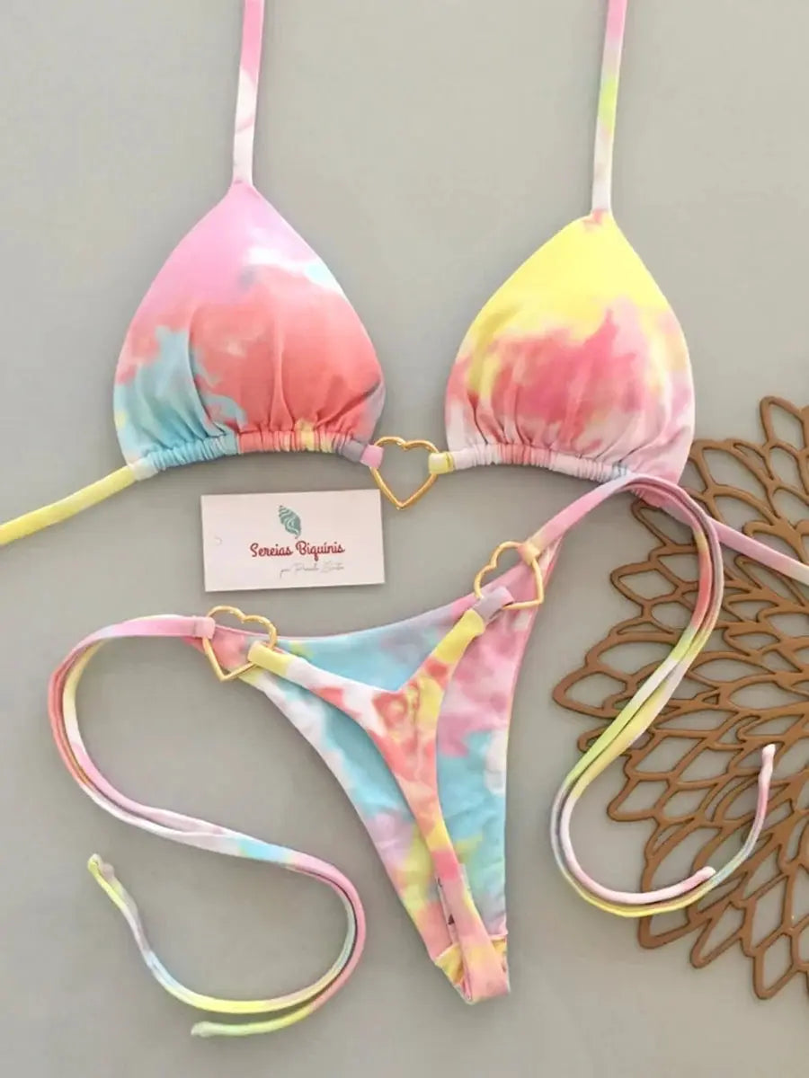 Pastel tie-dye two-piece micro bikini set with triangle halter top, heart-link accents, and matching thong bottom