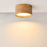 GX53 wooden ceiling lamp with natural wood drum shade, emitting a warm glow on the wall.