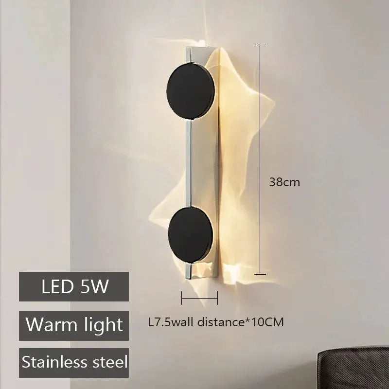 Simples Market modern rotatable LED wall light, stainless steel with two black circular discs, warm light.
