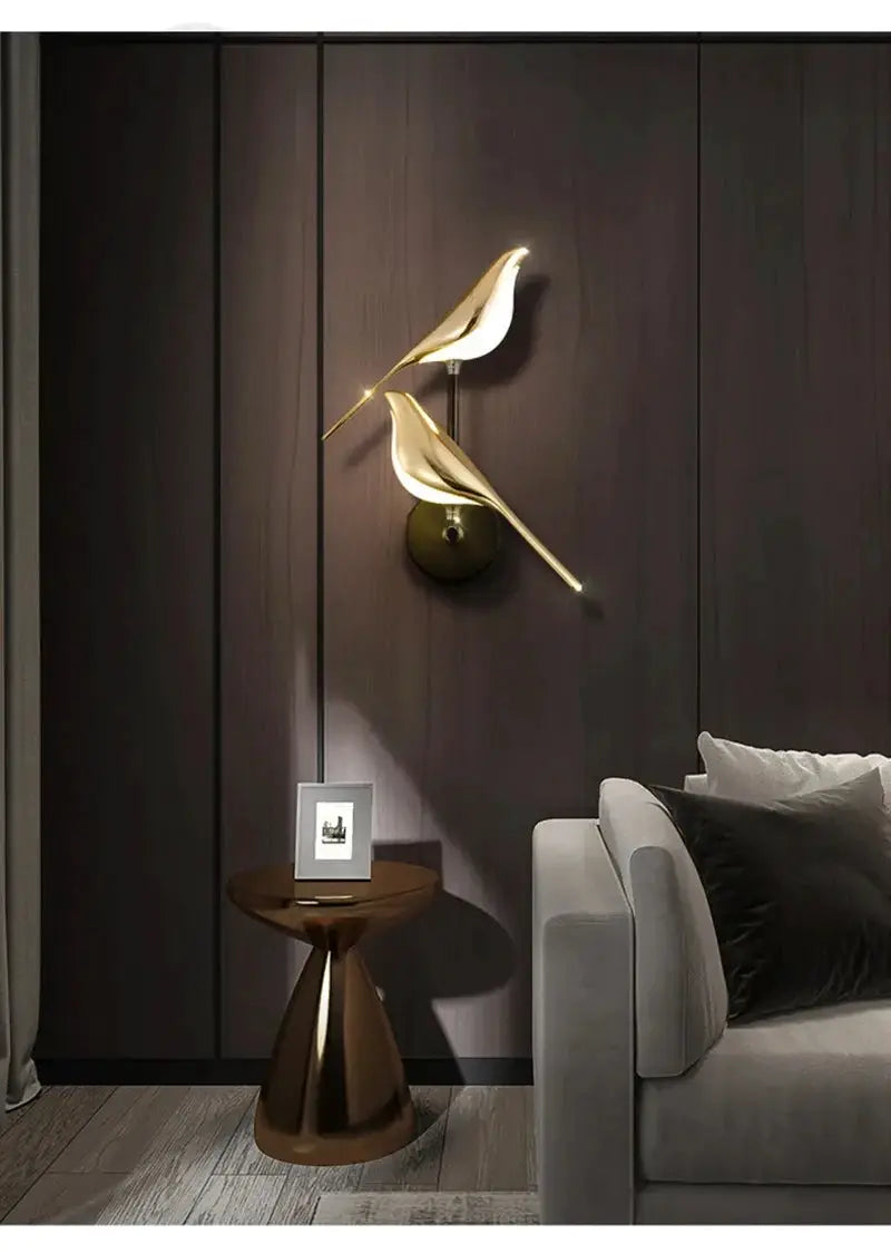 Modern LED wall lamp featuring two gold magpie bird sculptures on a brass mount by Simples Market.