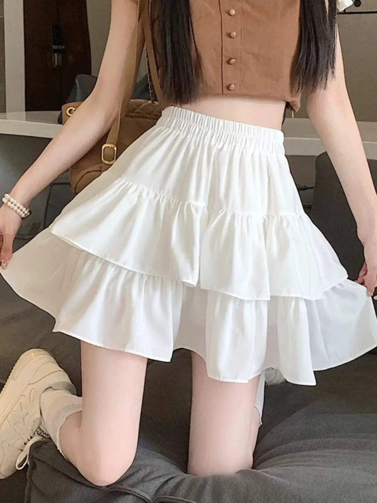 White mini A-line skirt with tiered ruffles and elastic waist