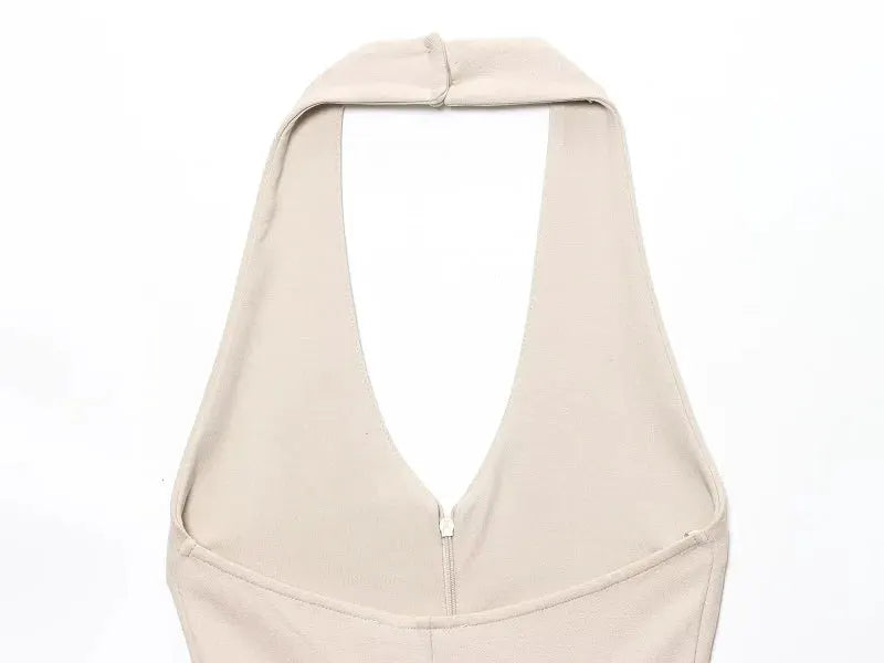 Beige halter-neck sleeveless backless jumpsuit with front zipper closure