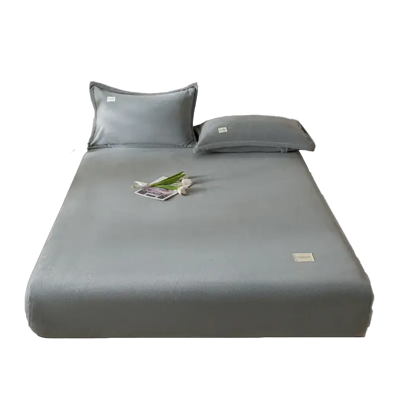 Velvet thermal mattress cover by Simples Market in gray-blue on a bed with two pillows