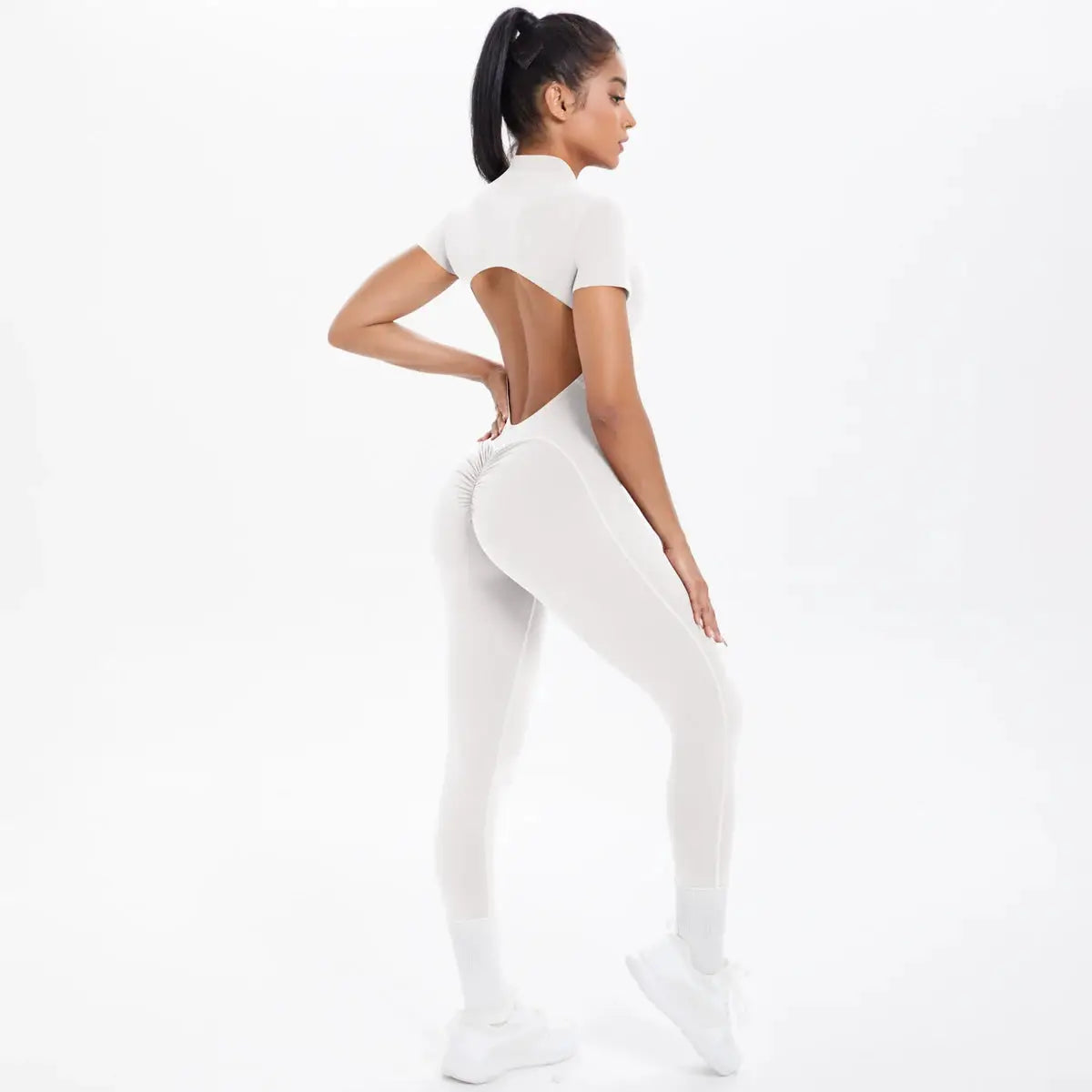 Short-sleeve white fitness jumpsuit with backless scrunch design for women; one-piece gym/yoga suit.