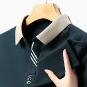 Men's short-sleeve polo shirt by Simples Market, navy with beige collar and striped placket, on hanger.
