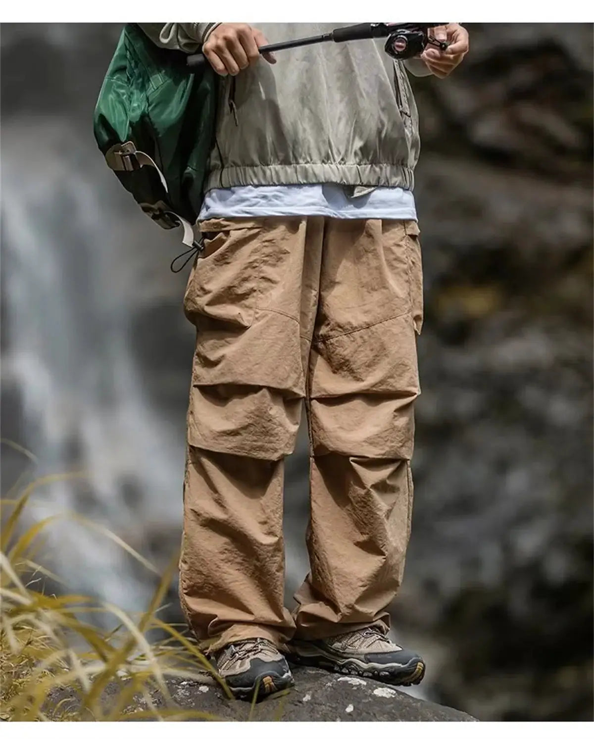 Men's tan cargo hiking pants with thigh pockets for outdoor wear.
