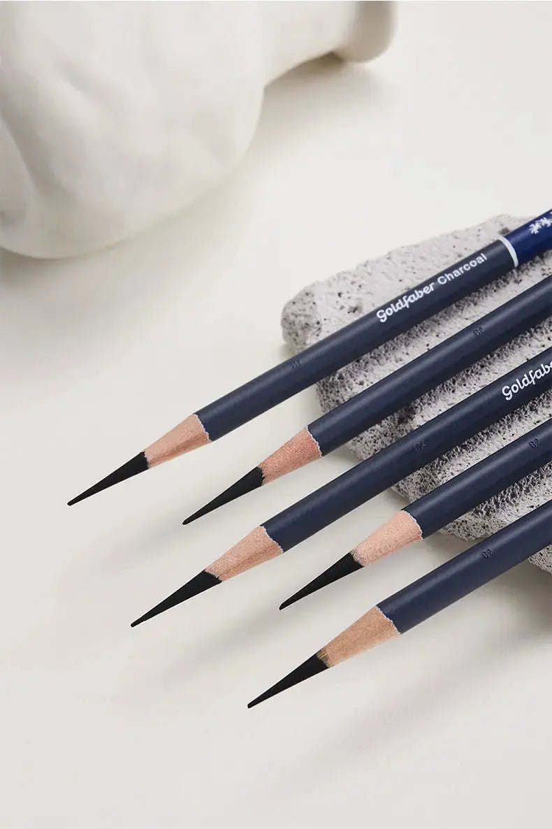 4 Goldfaber Charcoal graphite pencils in dark blue barrels with sharpened tips.