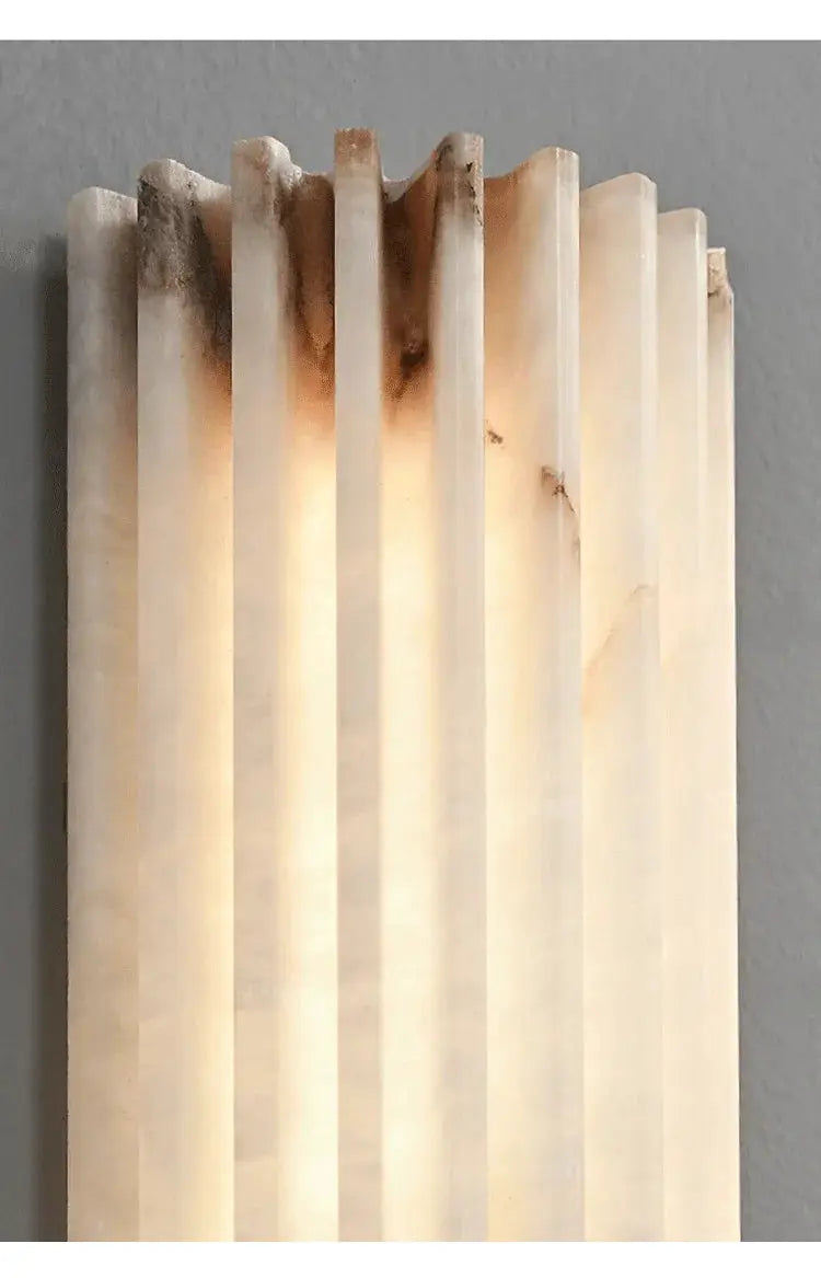Marble wall lamp with vertical slats and warm backlit glow by Simples Market