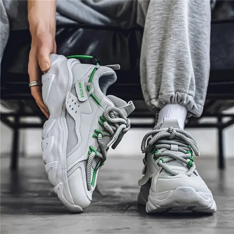 Men's breathable thick-soled sneakers in white/gray with green accents; pair shown for outdoor running.