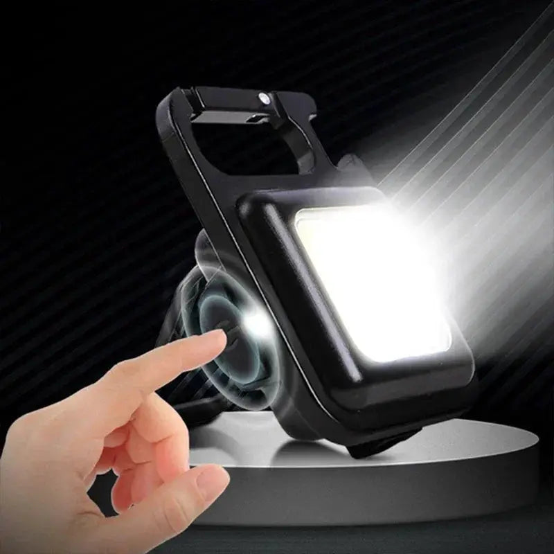 Keychain light mini camping flashlight with USB rechargeable COB LED, black pocket clip lantern for outdoor use.