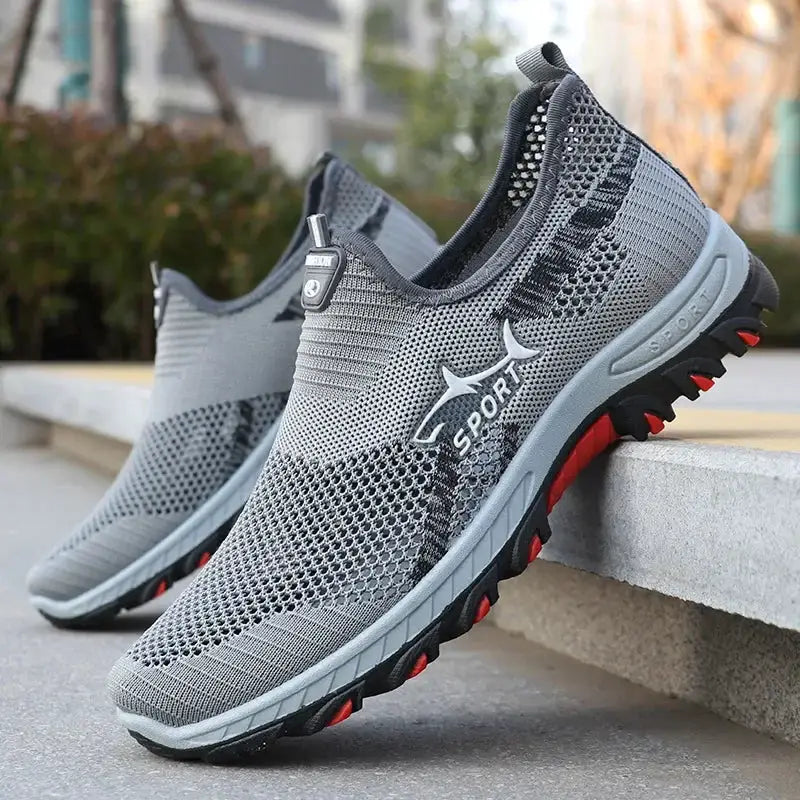 Pair of men's gray mesh sport sneakers with breathable knit upper and red outsole