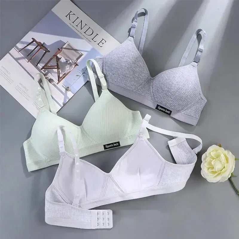 Three cotton wireless V-Bra bras in gray, mint, and white from Simples Market with a Sports Belt label.