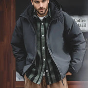 Maden hooded down jacket for men in black, worn open over a green plaid shirt