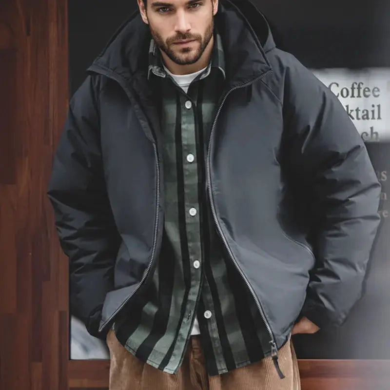 Maden hooded down jacket for men in black, worn open over a green plaid shirt