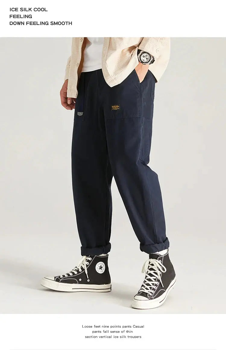 HIQOR men's navy cargo pants with multiple pockets, baggy fit and cuffed hems.