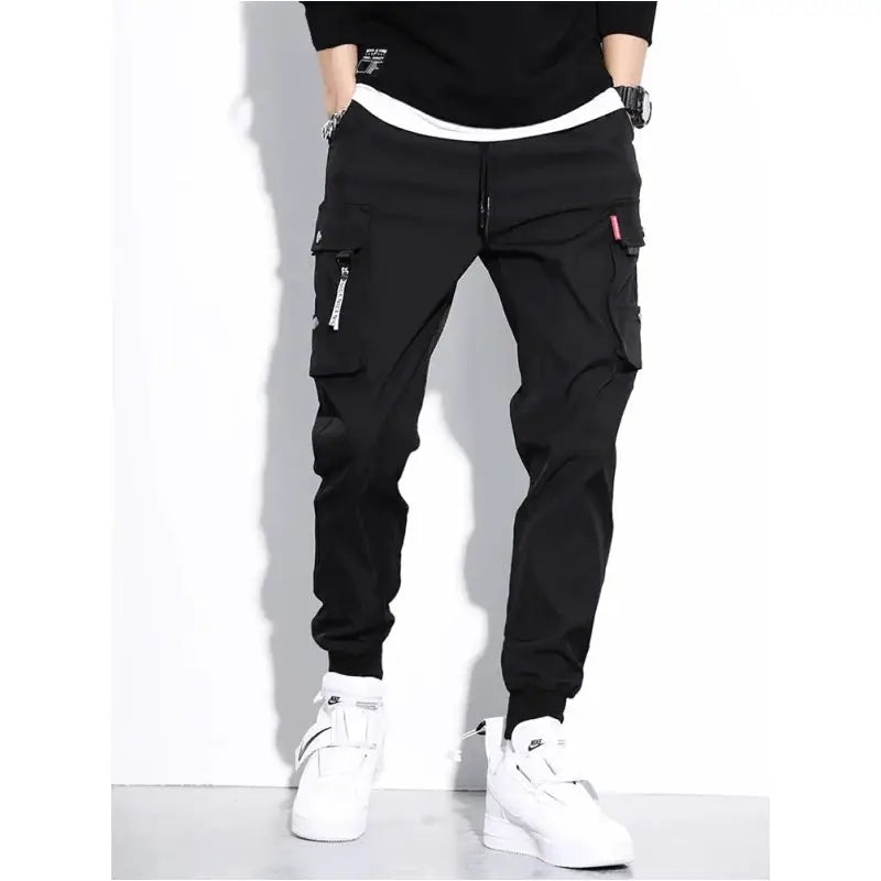 Men's black cargo work pants by Simples Market with multiple pockets and jogger cuffs.