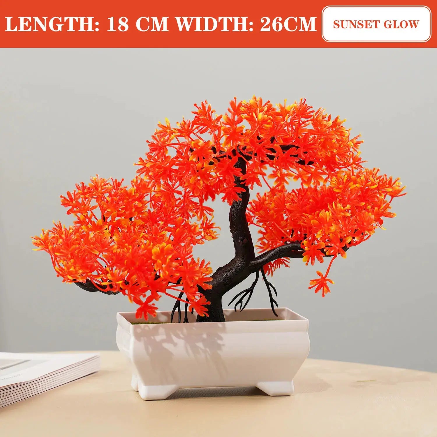 Artificial bonsai tree with bright orange blossoms in a white ceramic pot for tabletop home decor.