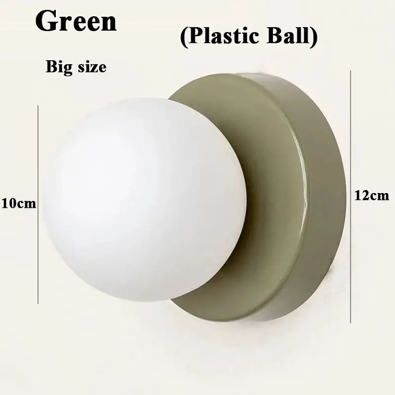 Wall sconce with green iron base and white plastic ball shade for modern home decor