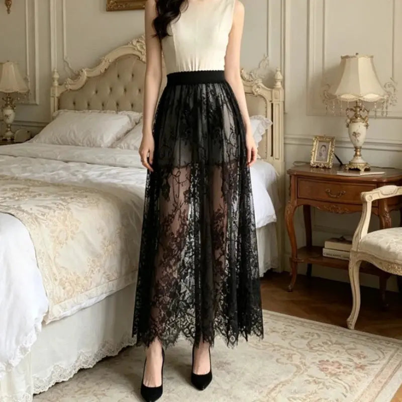 Long black lace tulle skirt with elastic high waist and sheer overlay, midi length.