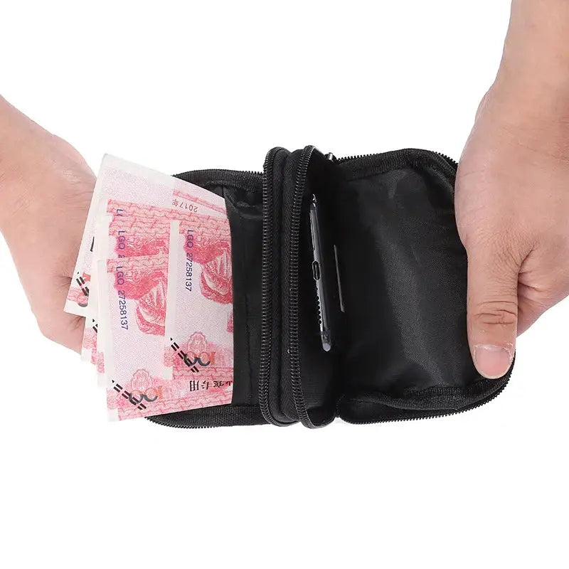 Black men's waist pack with multiple zip compartments, holding cash and a smartphone.