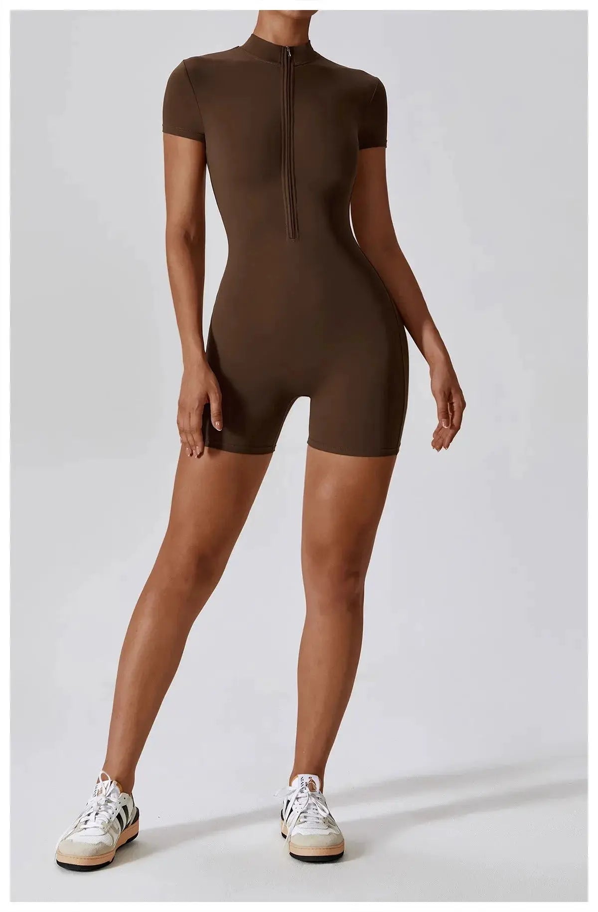 Women's brown zip-front short-sleeve yoga jumpsuit; quick-dry breathable, tight-fit one-piece for workouts.