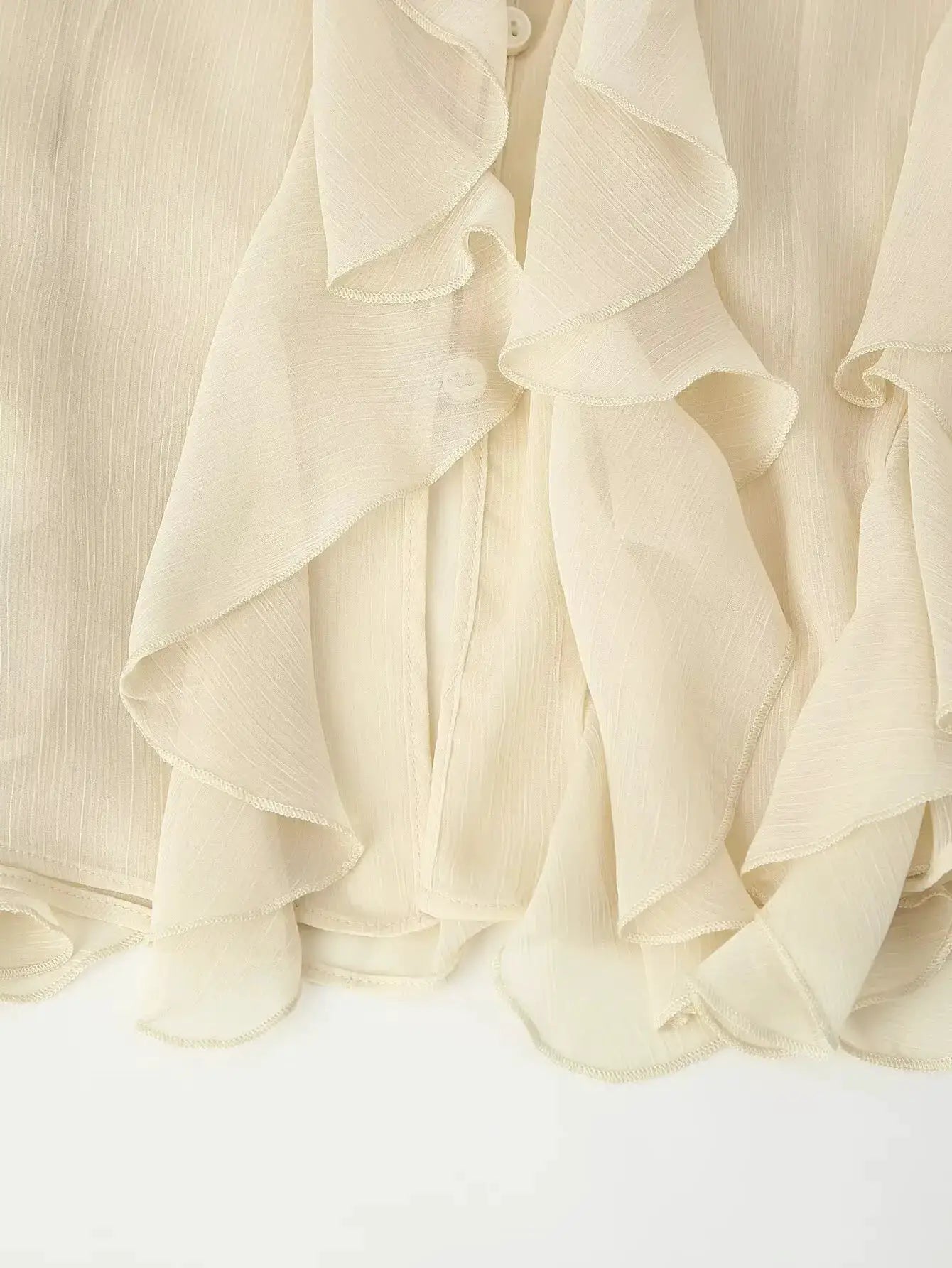 YENKYE cream semi-sheer ruffle blouse with cascading layers and long sleeves