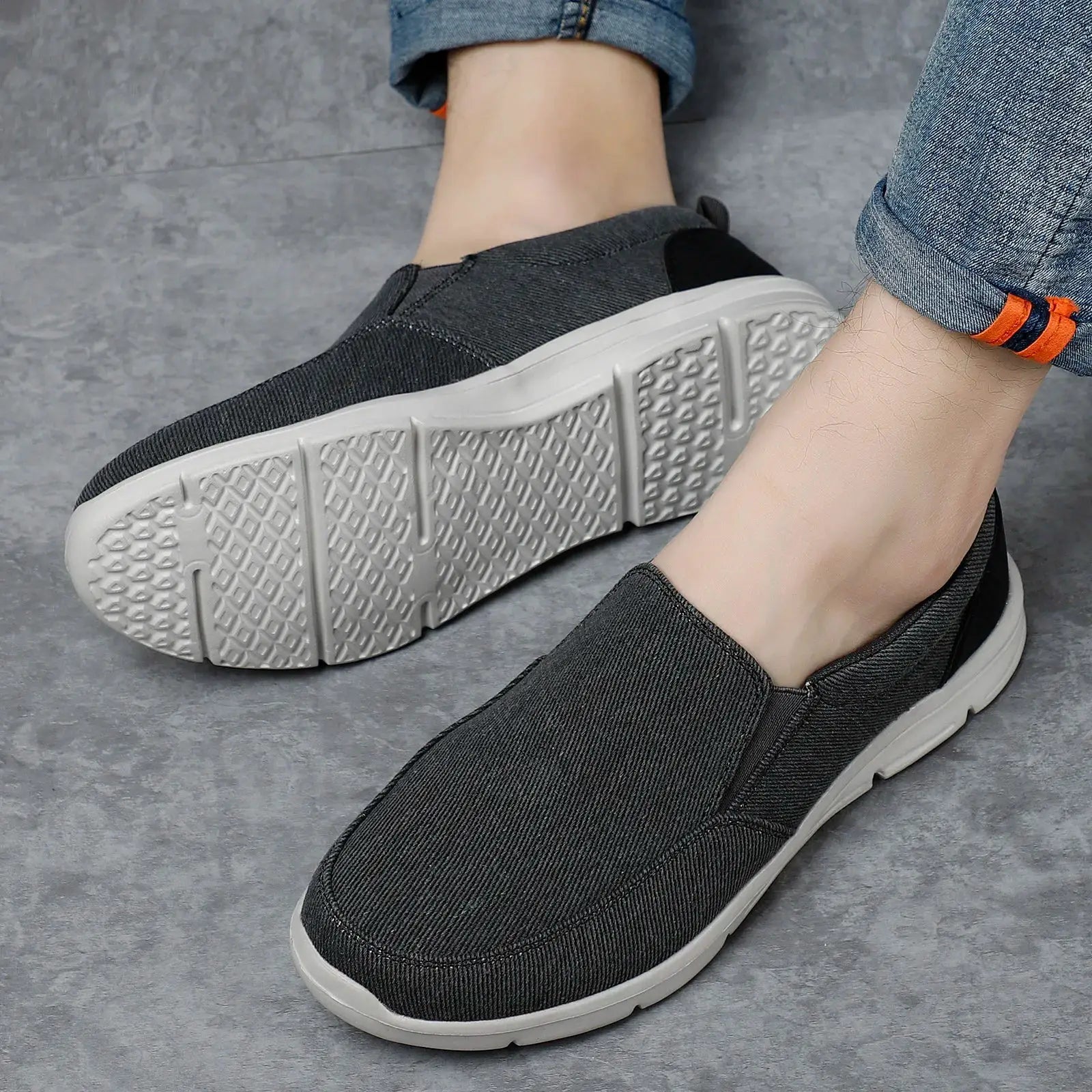 Men's dark gray canvas slip-on sneakers with white outsole, pair of casual outdoor loafers